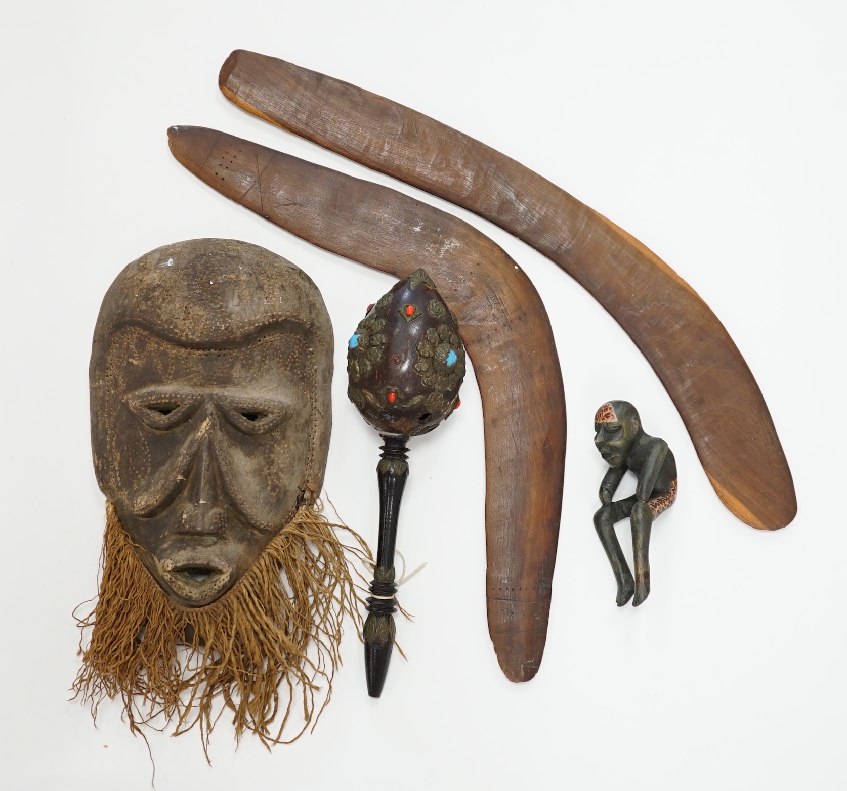 Two Aboriginal boomerangs, an African mask, a painted lion figure and four other items (8)
